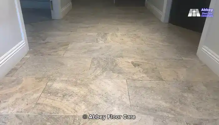 "Rotary machine and wet vacuum deep cleaning a tumbled travertine floor and extracting dirty slurry