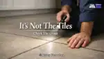 Wide shot of a porcelain floor in a UK home showing dull patches and light haze across the tiles.