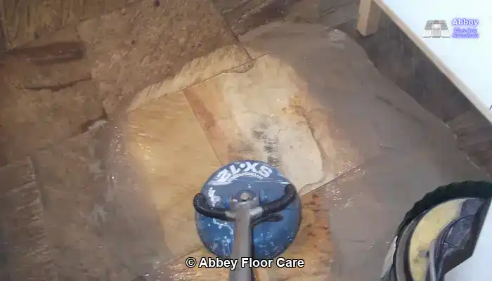 Professional sandstone floor cleaning using specialist equipment.