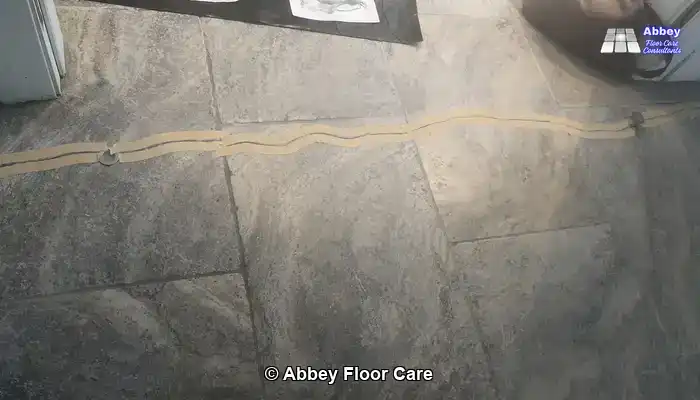 Close-up of crack repair and hole filling on a cleaned tumbled travertine tile