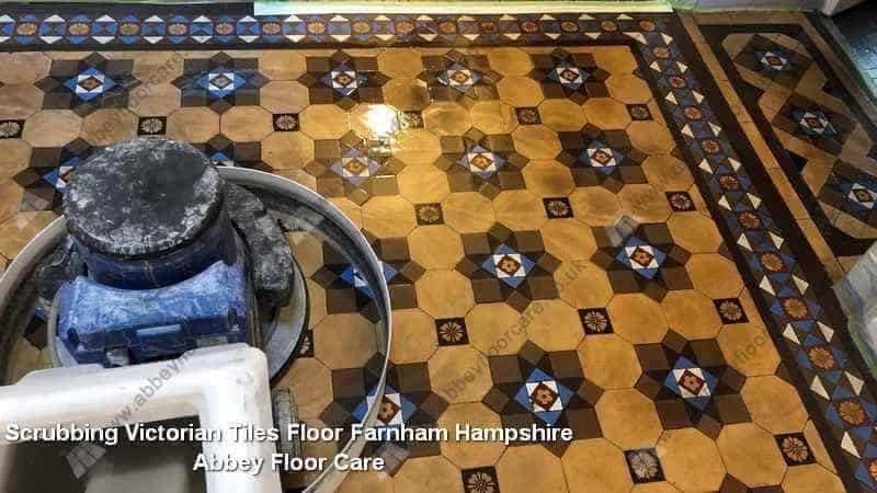 Surface residues being agitated during cleaning of a Victorian tiled hallway floor in Farnham