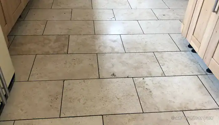Travertine in heavy use kitchen with degraded impregnating sealer