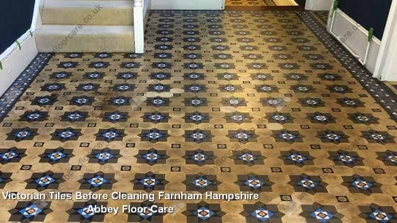 Victorian tiled hallway floor in Farnham showing heavy soiling and patchy staining before cleaning