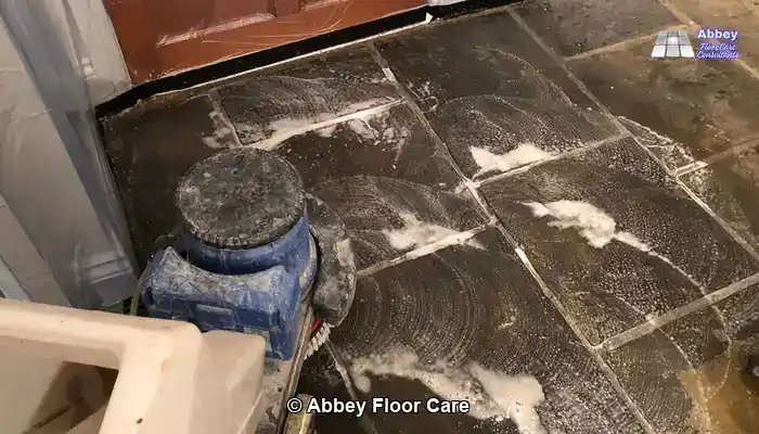 Rotary scrubbing removing deep-set soil from riven sandstone prior to sealing