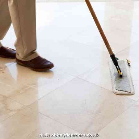 dry sweeping a marble floor