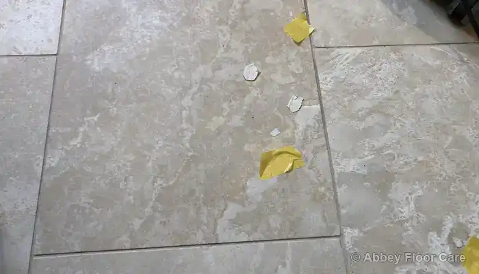 Open holes in a travertine floor where the stone surface had broken down.