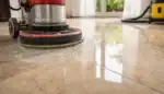 Marble tiles being honed with diamond abrasives to remove surface damage