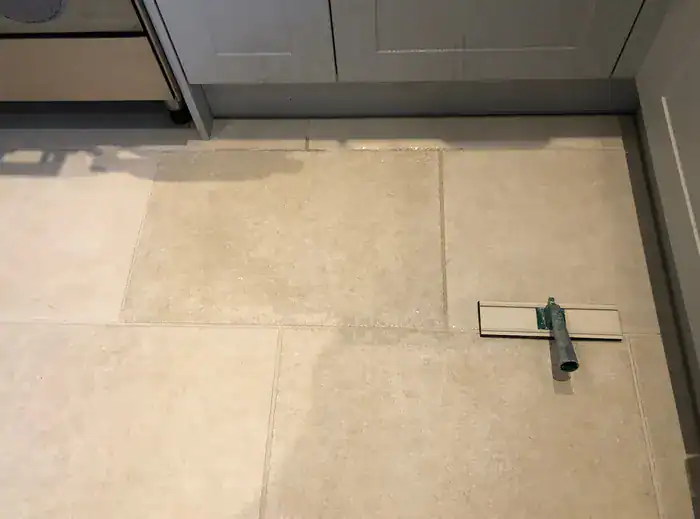 Diagram of grout sealer protecting porous grout from spills