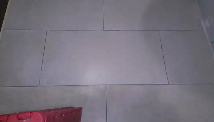 Dull and uneven limestone bathroom floor surface on inspection