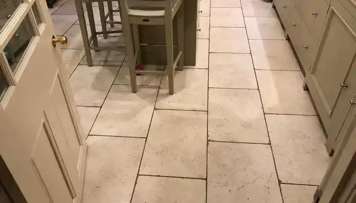 Limestone surface showing dull patches and light wear that no longer respond to cleaning