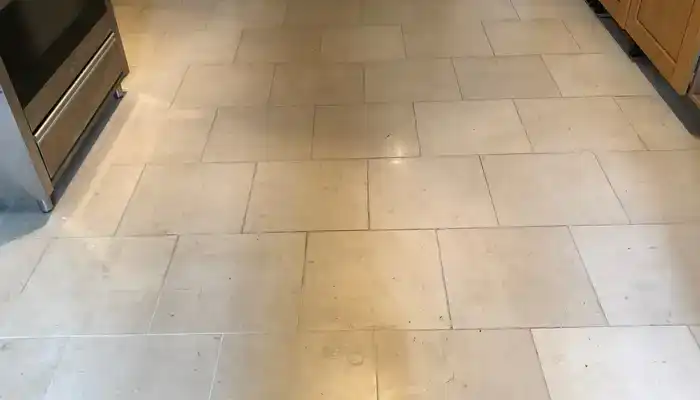 Limestone flooring in a kitchen environment showing everyday wear