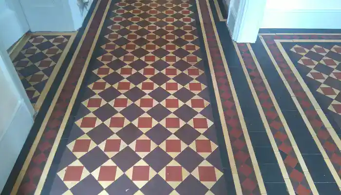 Minton clay tile floor after restoration with colour and pattern visible