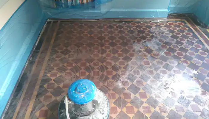 Old sealers and adhesives being removed from an original Minton tile floor