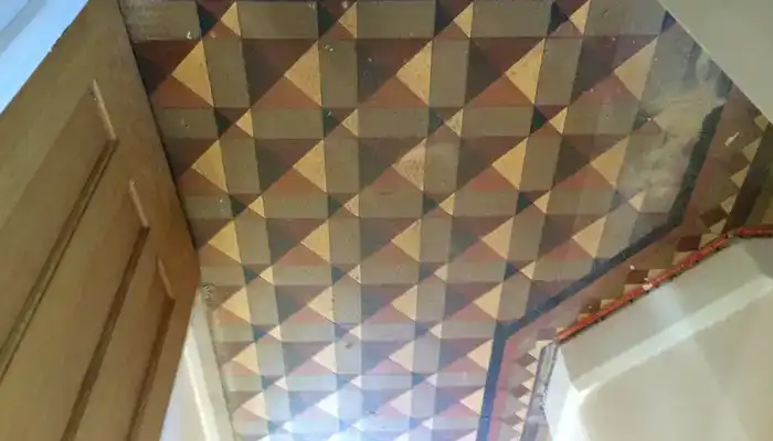 Dull Minton tile floor with ingrained soiling in a Tutbury property