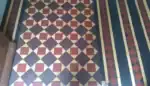 Decorative Minton tile floor in a traditional UK property, illustrating the type of heritage flooring typically assessed when pricing restoration work.
