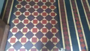 Decorative Minton tile floor in a traditional UK property, illustrating the type of heritage flooring typically assessed when pricing restoration work.