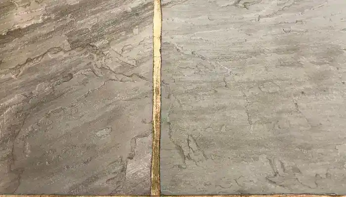 Close-up of riven slate showing textured surface where dirt can settle.