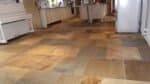 Sandstone floor in a UK kitchen showing natural colour variation and matte finish