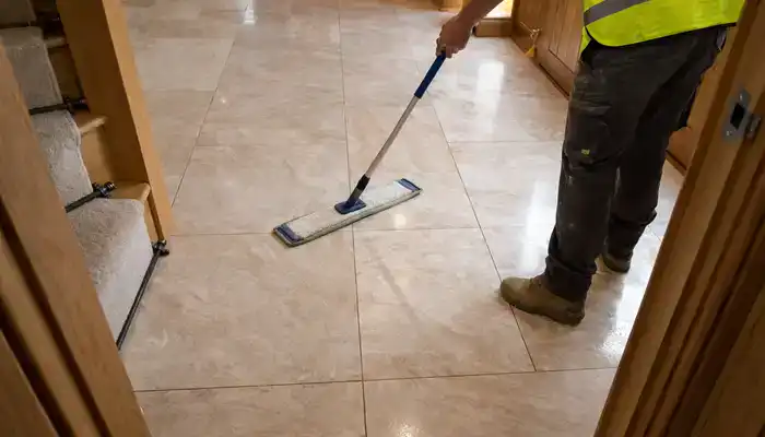 Microfibre flat mop being used on a marble floor with no excess water, in a UK hallway