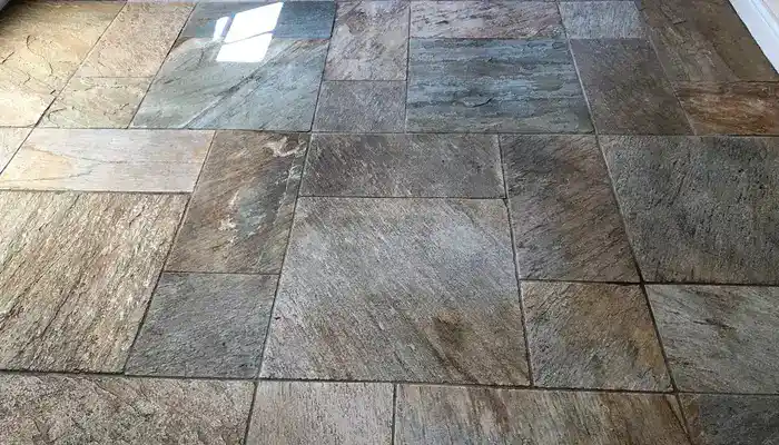 Slate floor that looks dull and patchy even though it has been recently cleaned.