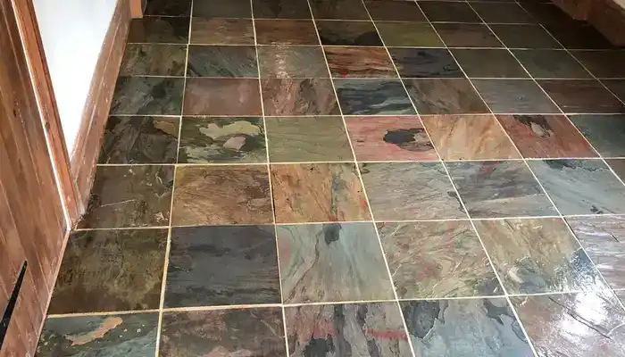 Slate floor with improved colour balance and clarity after underlying issues are addressed.