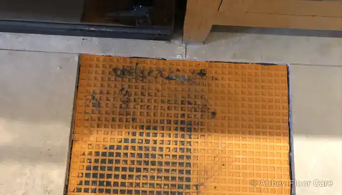 Repaired subfloor area prepared to support replacement travertine tiles.