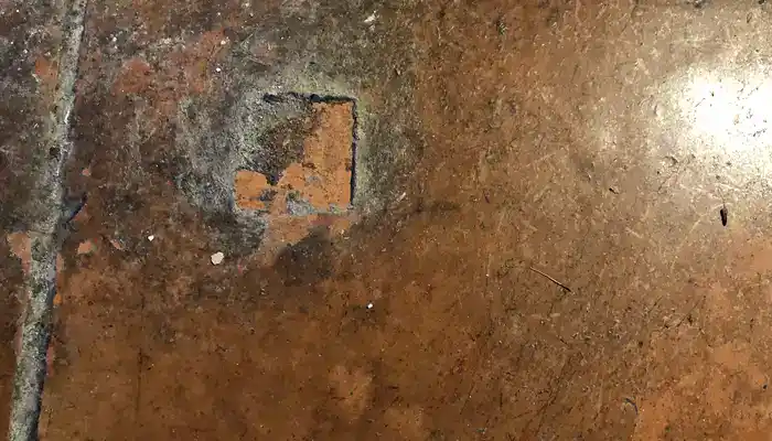 Patchy terracotta tiles caused by old sealer build-up and trapped dirt