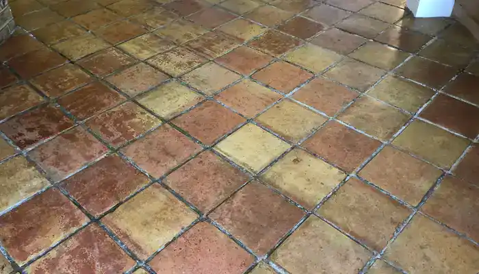 Terracotta floor with sticky, cloudy patches caused by sealer build-up and incorrect cleaning