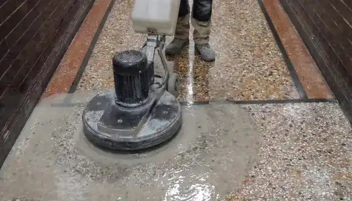 Honing a terrazzo floor to remove wear and refine the surface