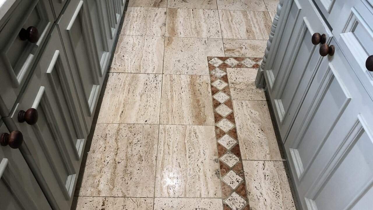 Travertine floor in a lived-in kitchen showing natural variation and surface texture